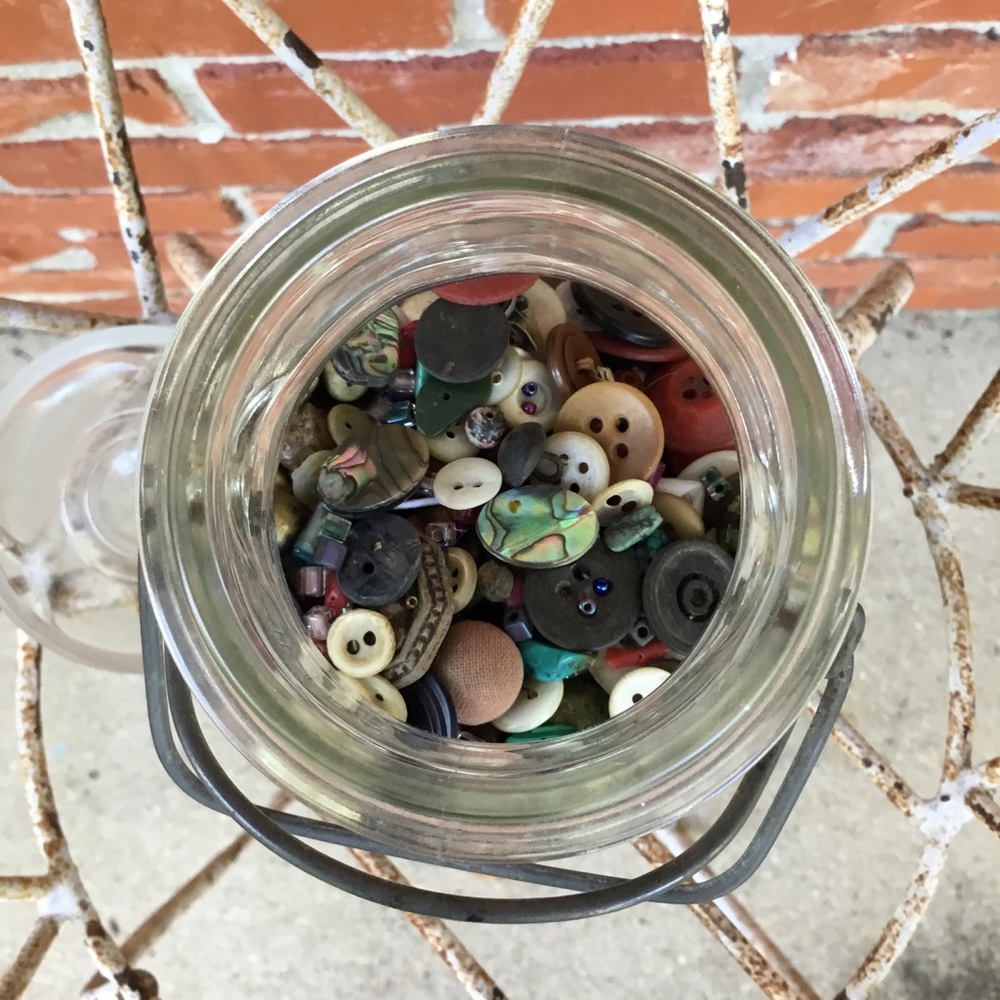 Buttons and beads in vintage mason jar.